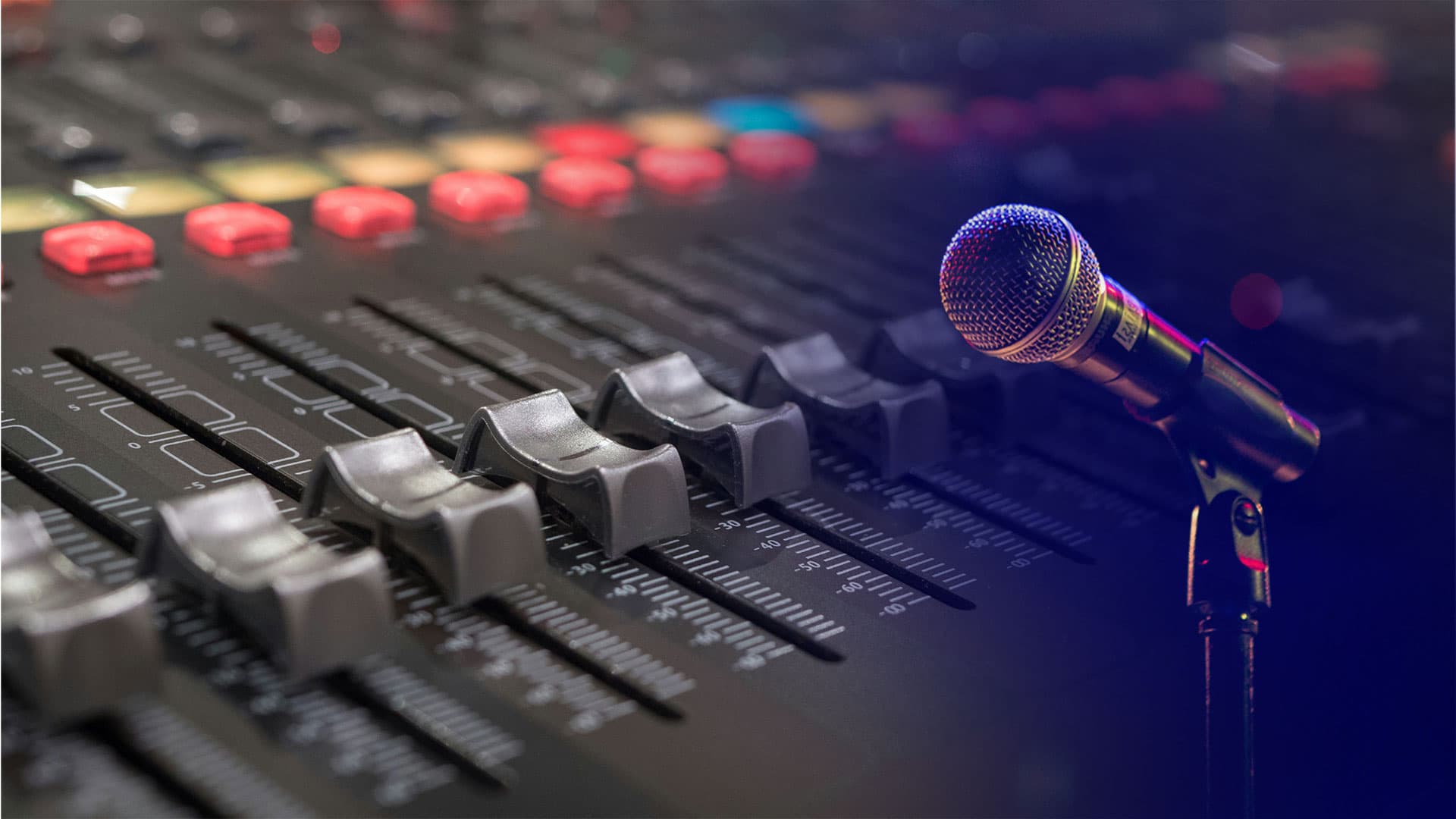 Microphone and audio mixing desk in a production setting